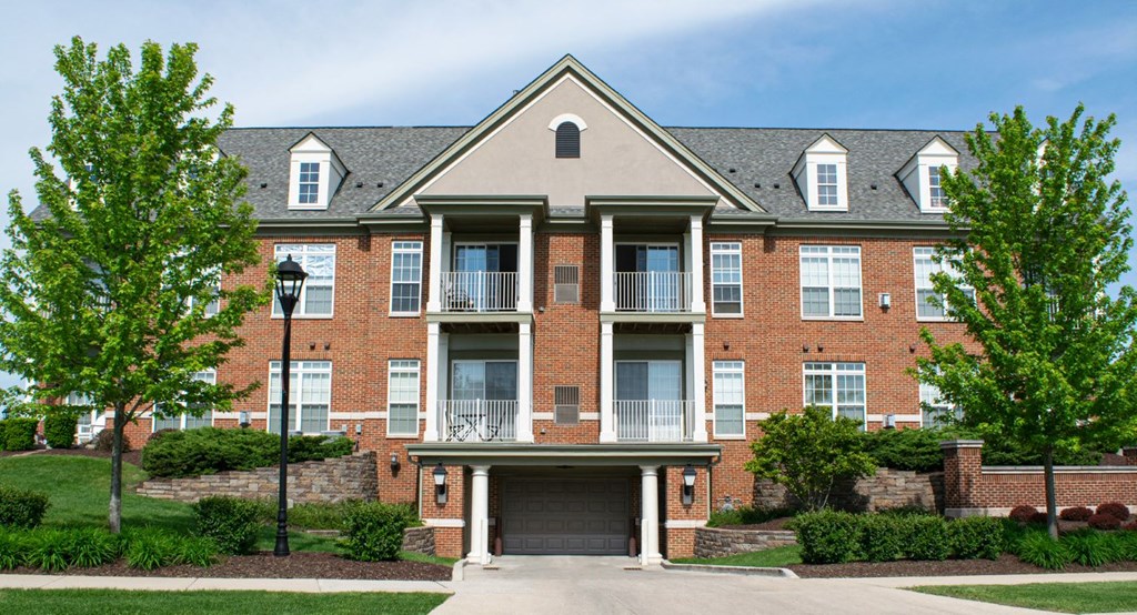 a large brick apartment building with a garage