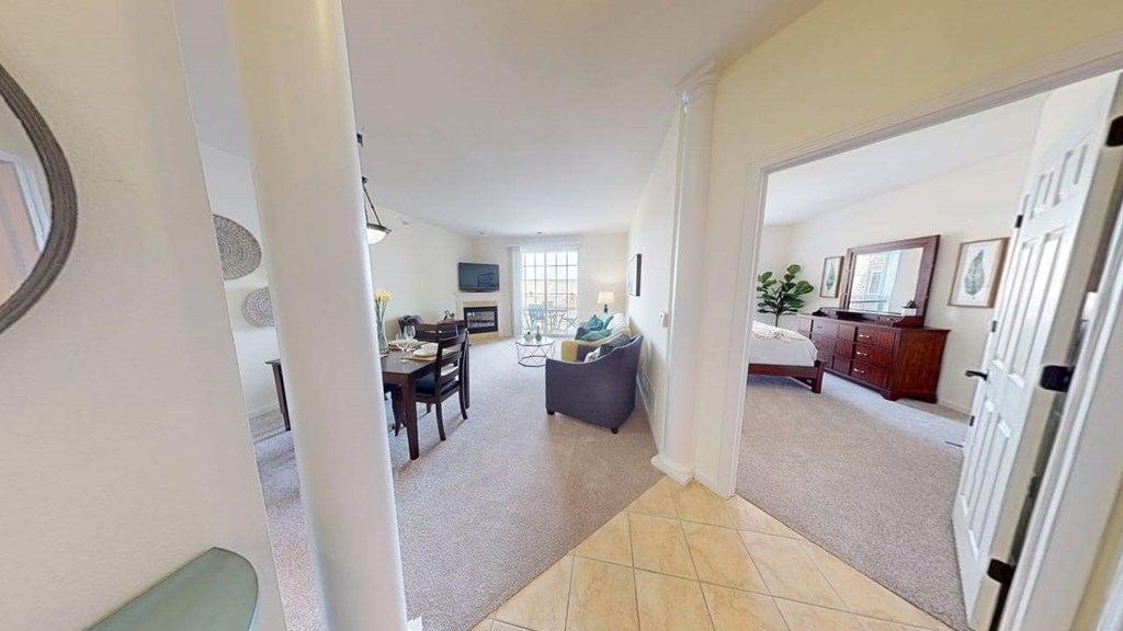 A living room with a couch, a chair, and a television.