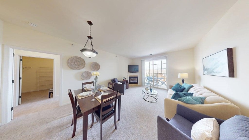 A living room with a dining table and a couch.