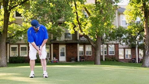 a man is playing golf on a golf course