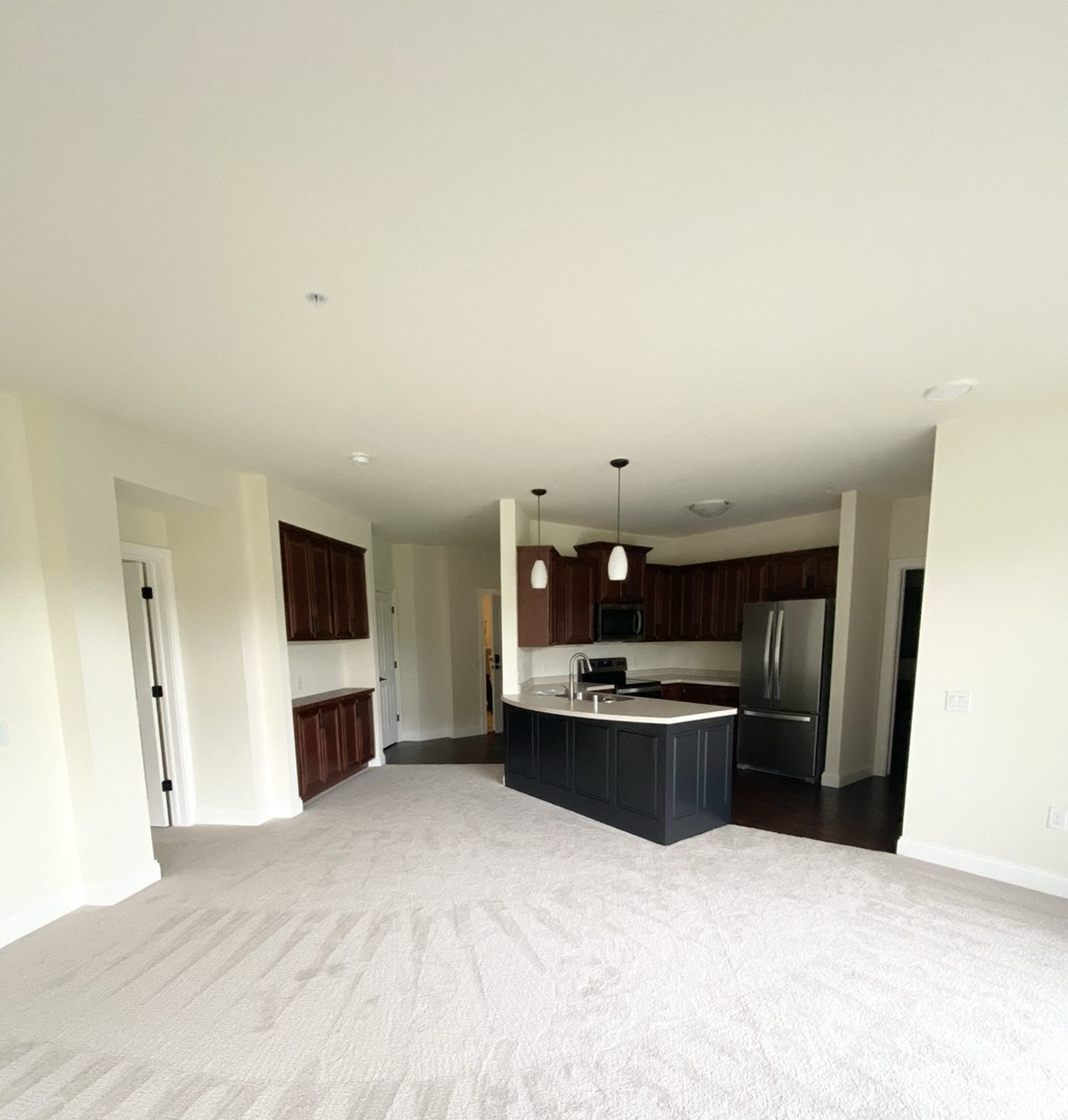 an empty living room and kitchen in a house