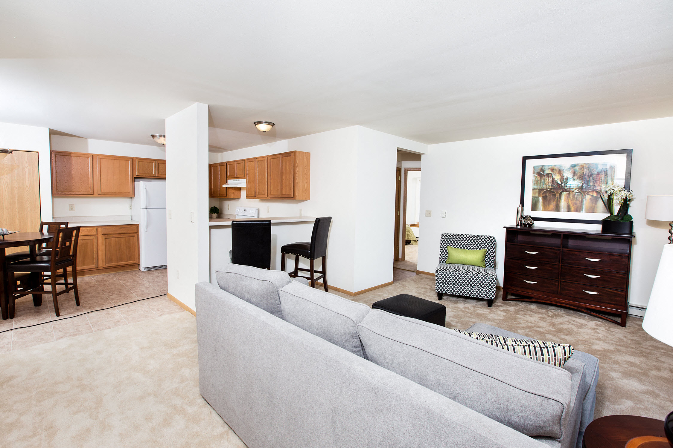 a living room and kitchen with a couch and a table