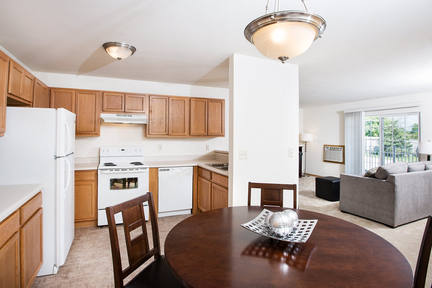 a kitchen and dining room with a table and chairs