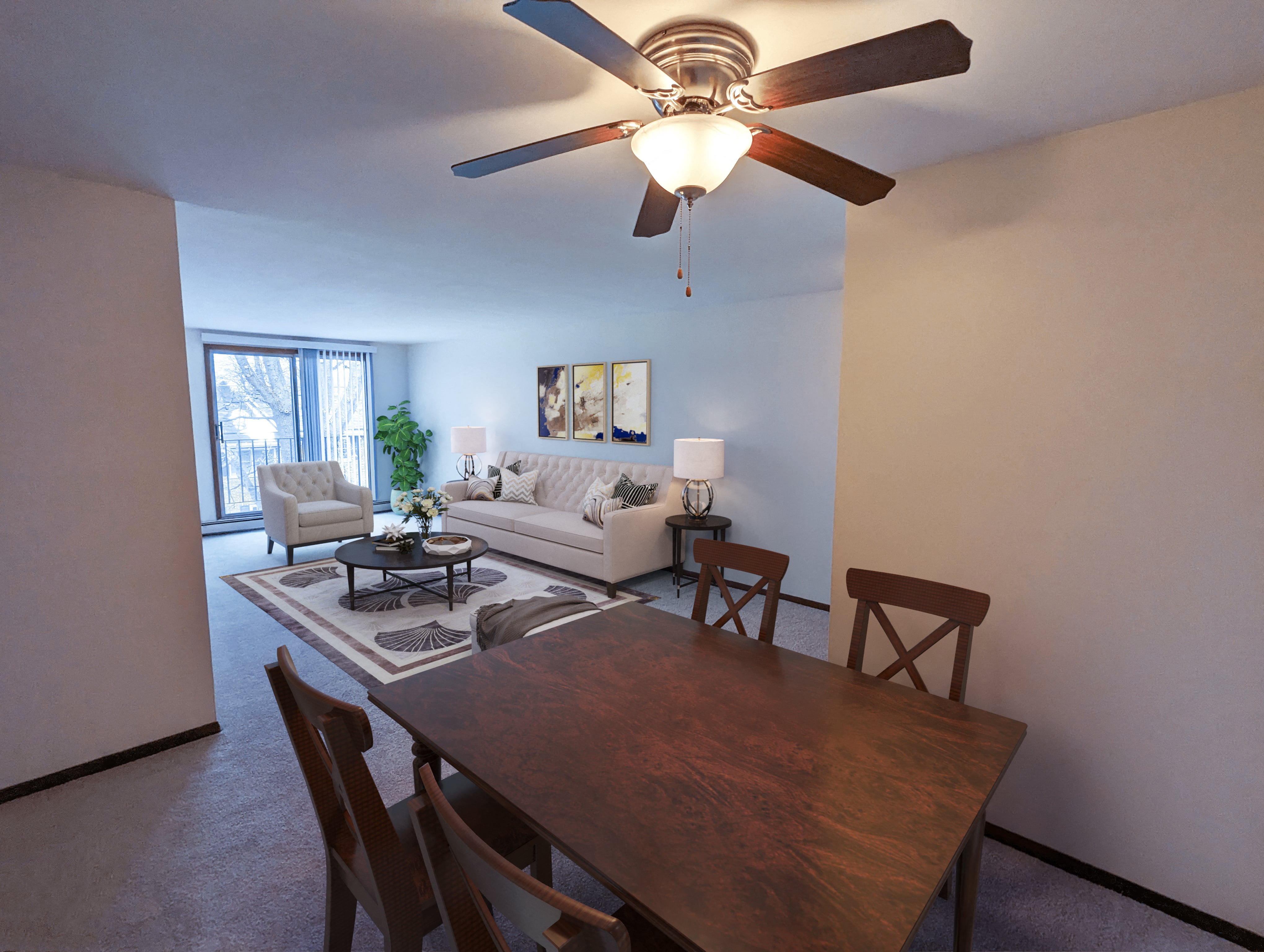 a living room with a dining room table and a ceiling fan