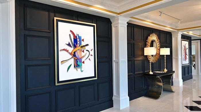 a room with a painting on the wall and a table