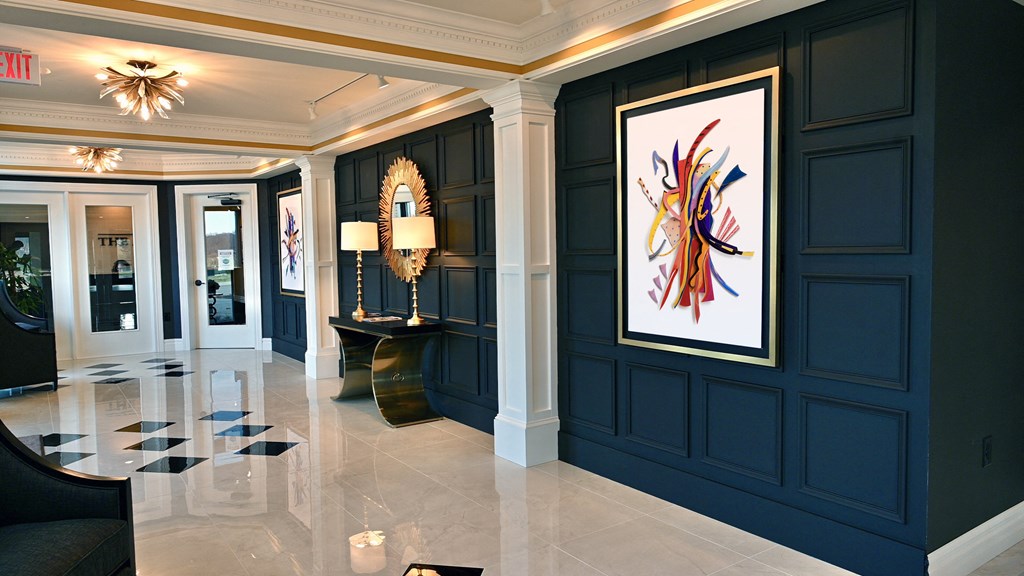 a lobby with blue walls and a painting on the wall