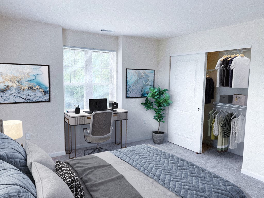 a bedroom with a bed and a desk and a closet