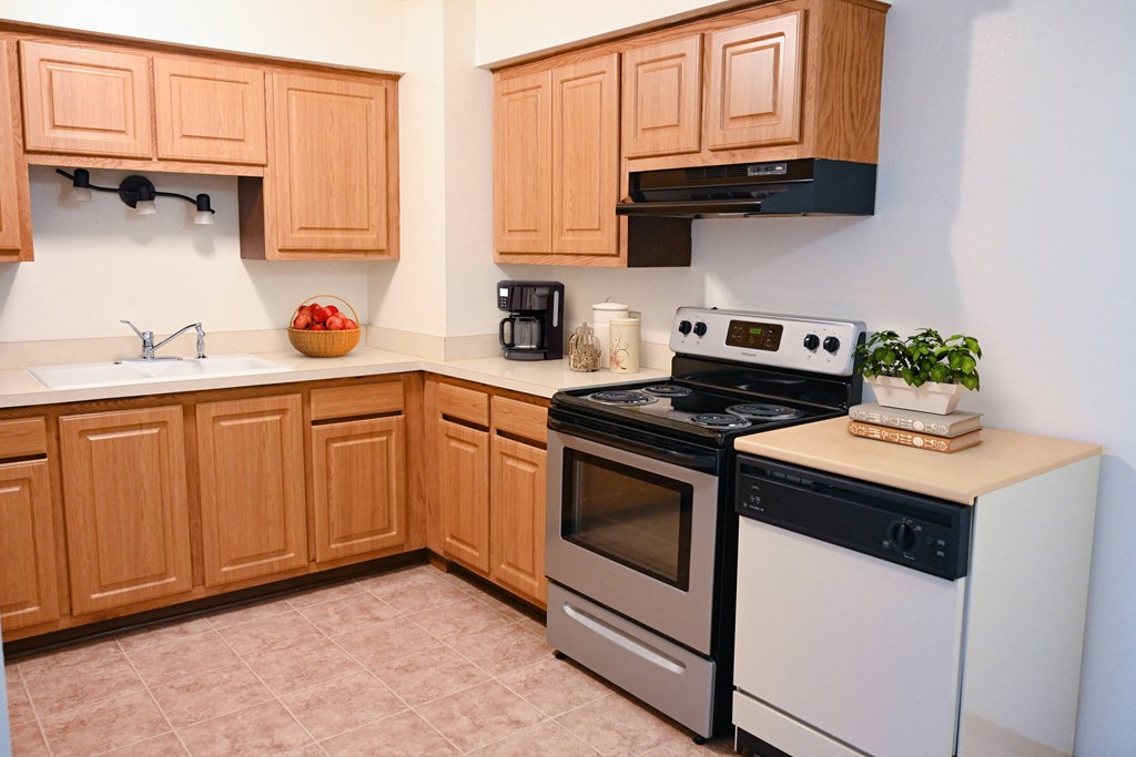 a kitchen with white appliances and wooden cabinets