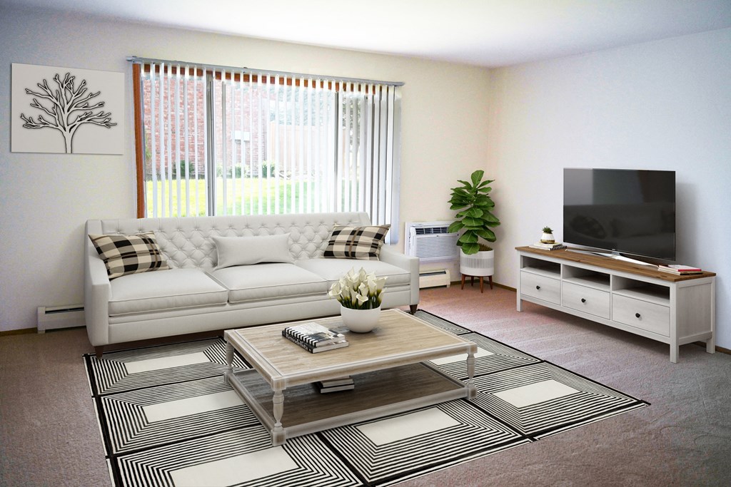 a living room with a white couch and a television