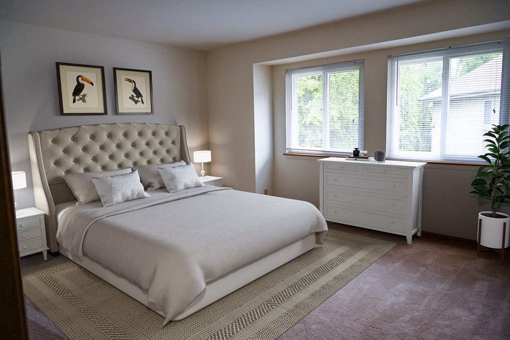 a bedroom with a bed and two windows