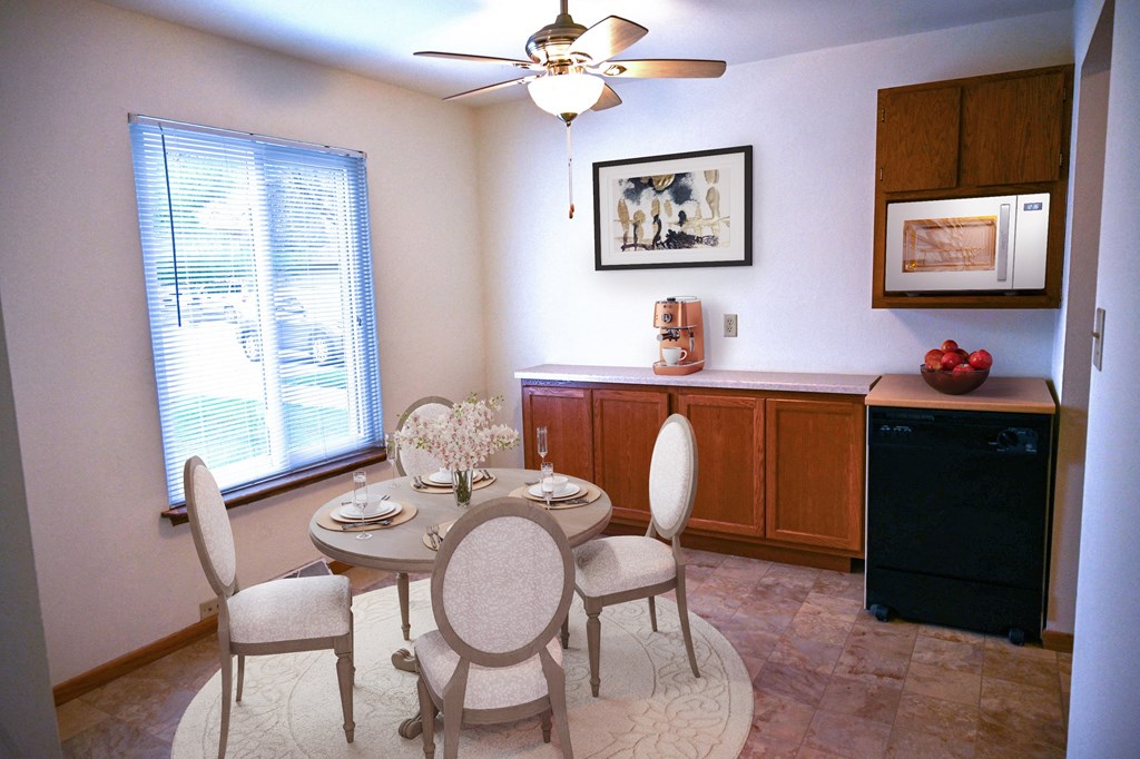 a dining room with a table and chairs and a kitchen