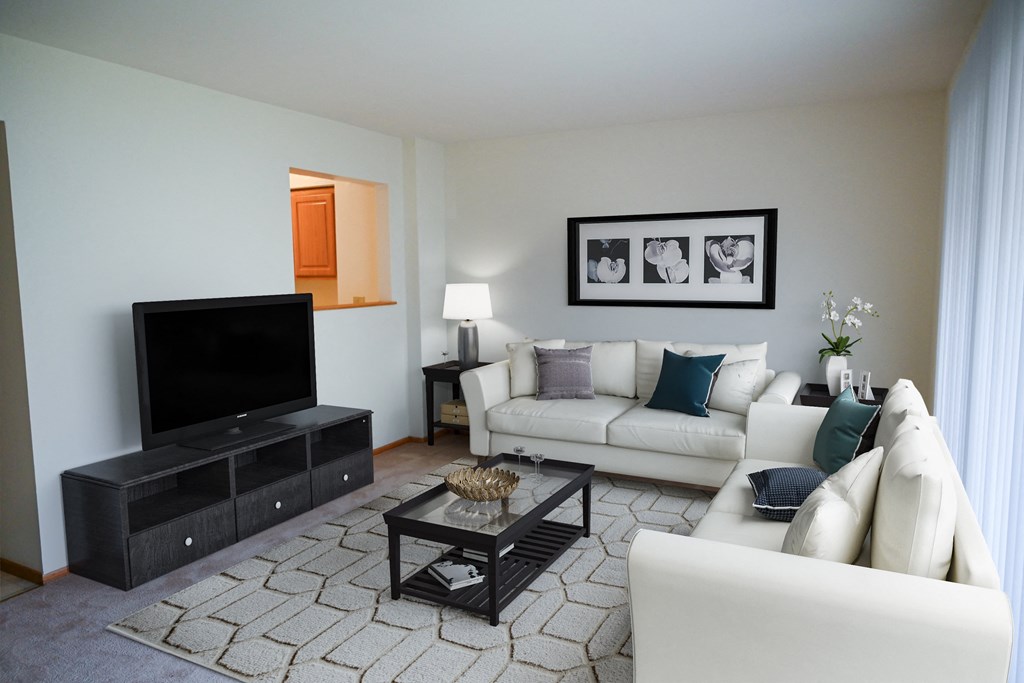 a living room with a white couch and a television