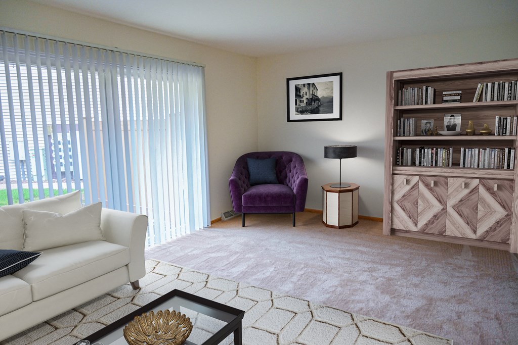 a living room with a white couch and a purple chair