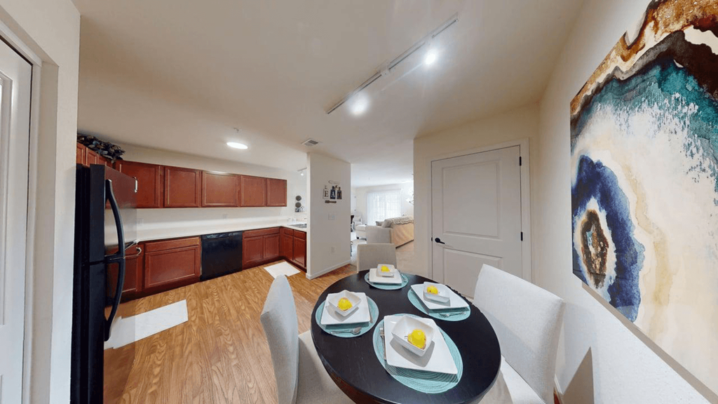 A dining table with four place settings is in the middle of a room.