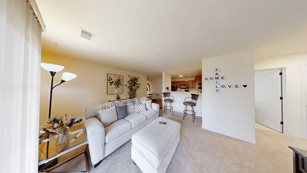 A living room with a white couch and a coffee table.