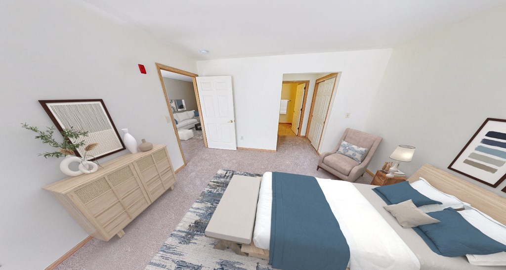 a bedroom with a bed and a chair and a dresser