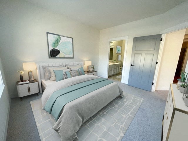 a bedroom with a bed and a door to a bathroom