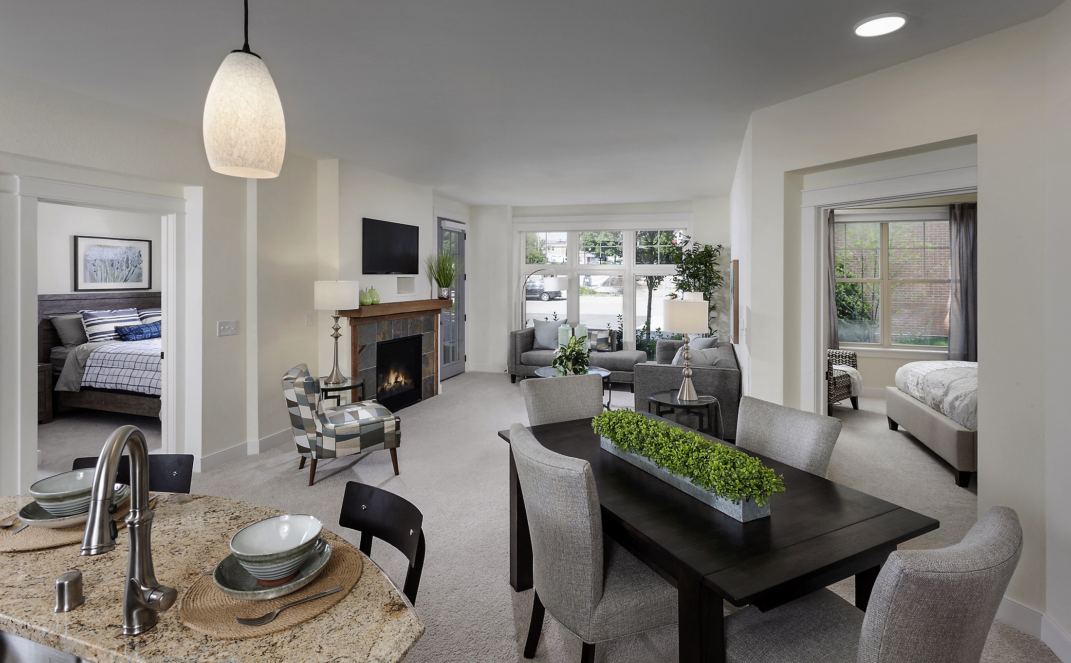 a living room with a table and chairs and a fireplace