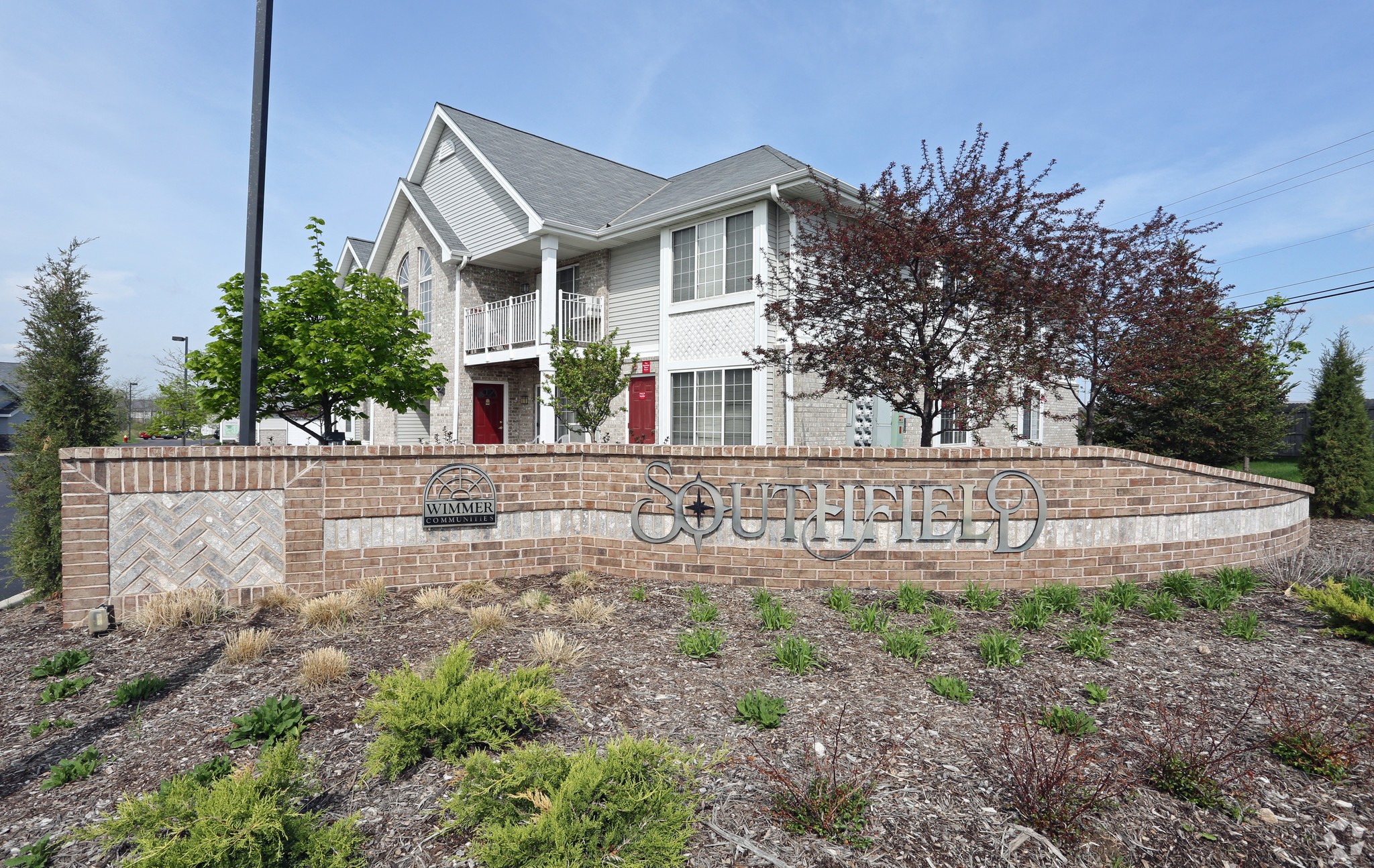 a brick retaining wall in front of a house
