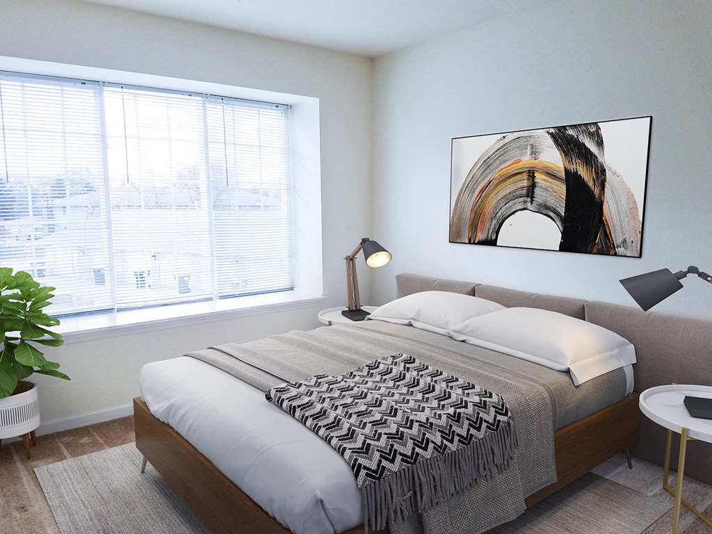 a bedroom with a bed and a large window