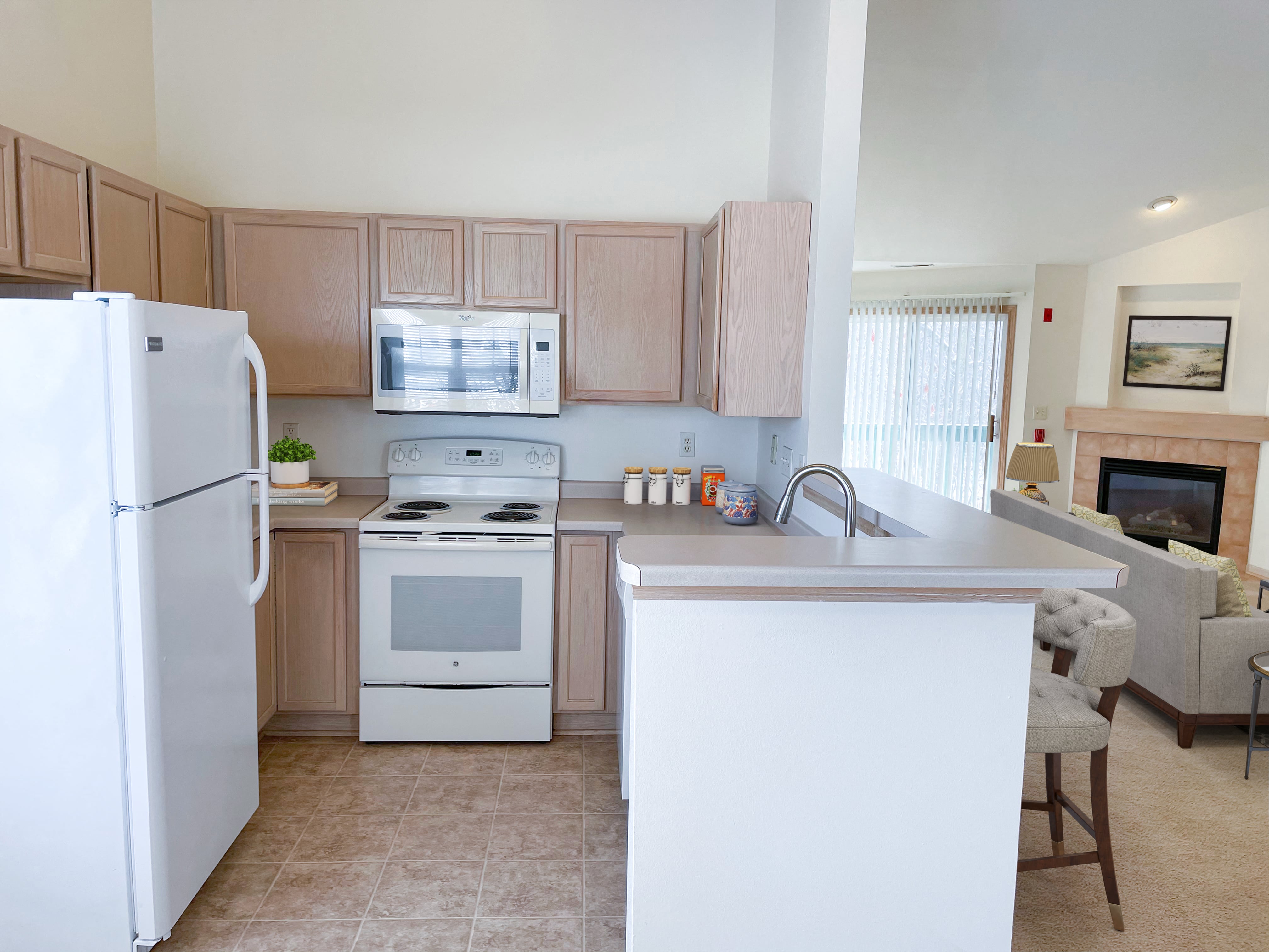 a kitchen with white appliances and wooden cabinets