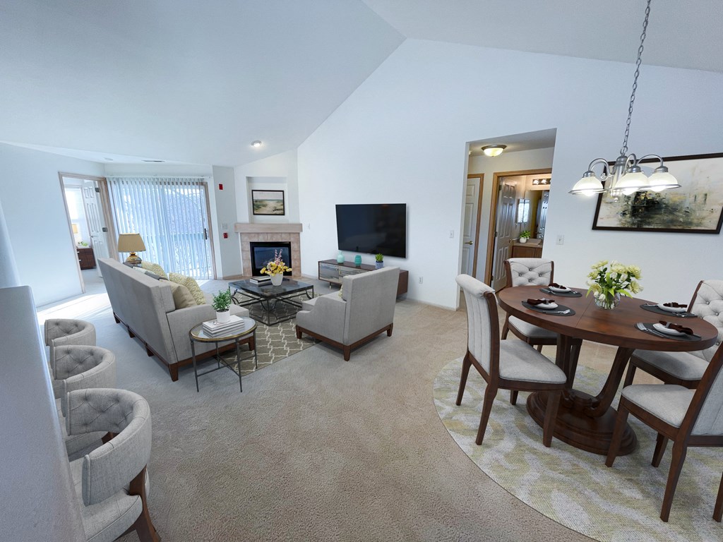 the living room and dining room of a home with a table and chairs
