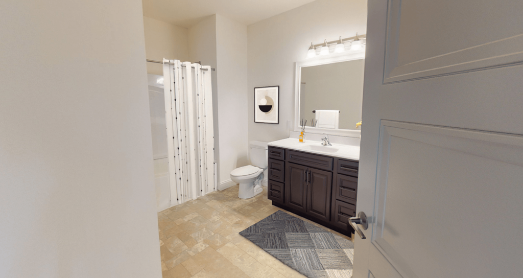 a bathroom with a toilet and a sink and a shower