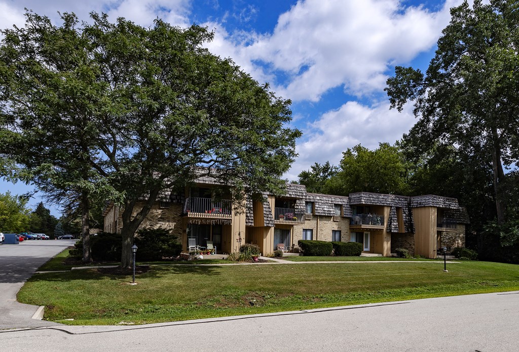 the view of an apartment building from the street
