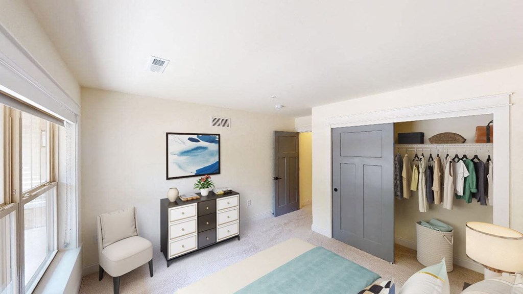 a bedroom with a bed and a closet with a blue door