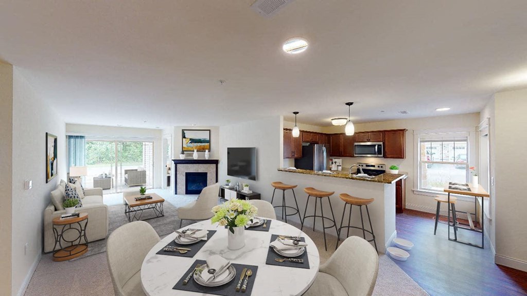 a kitchen and living room with a table and chairs