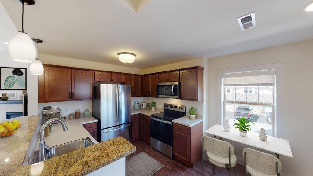 a kitchen with stainless steel appliances and granite counter tops