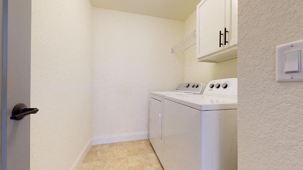 a laundry room with a washer and dryer in it