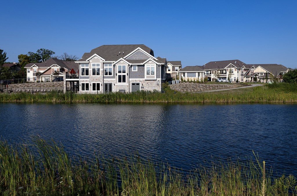 a house sits next to a body of water