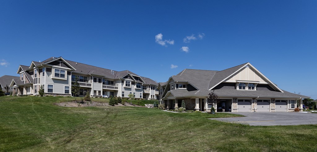a group of houses on a hill with a blue sky