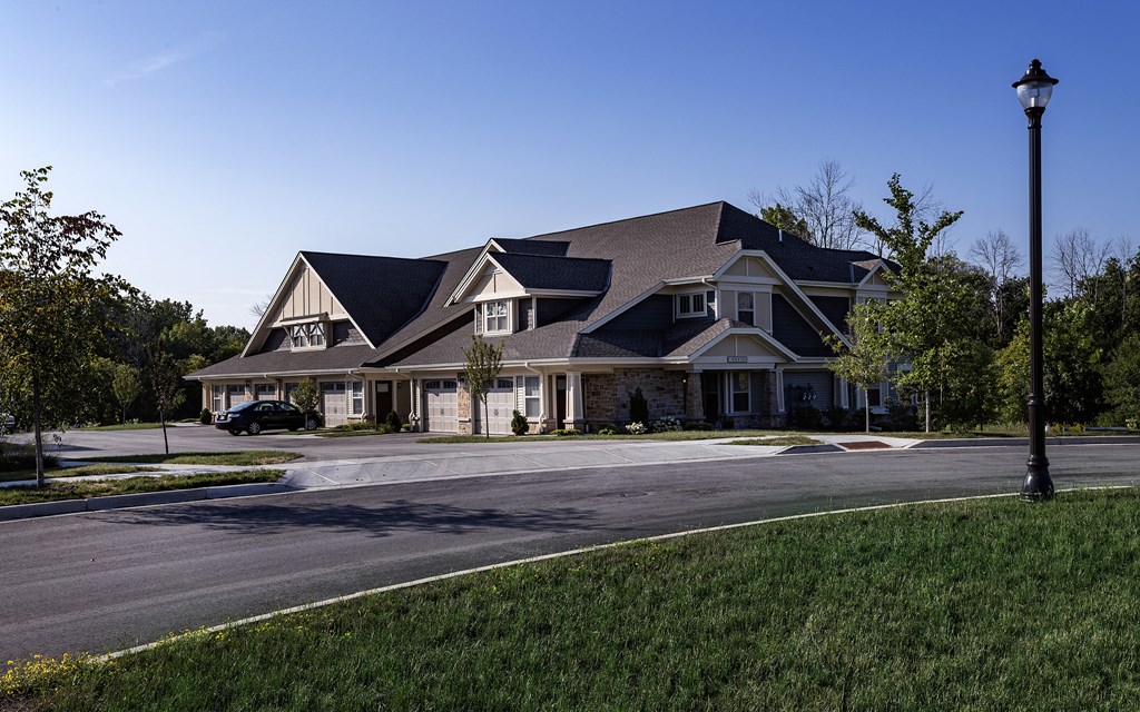 a large house on a street corner with a street light