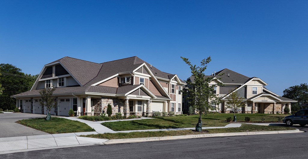 a group of houses on a street with a blue sky