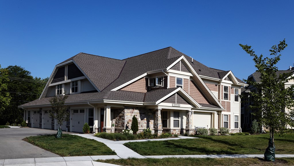 a large house with a large yard and sidewalk in front of it