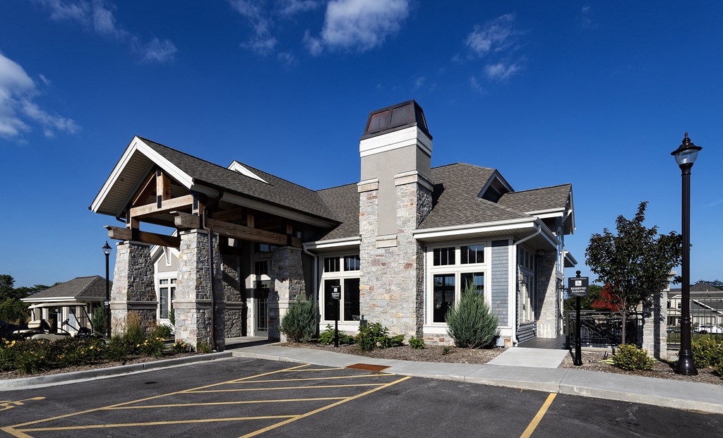 a view of the front of a building with a parking lot
