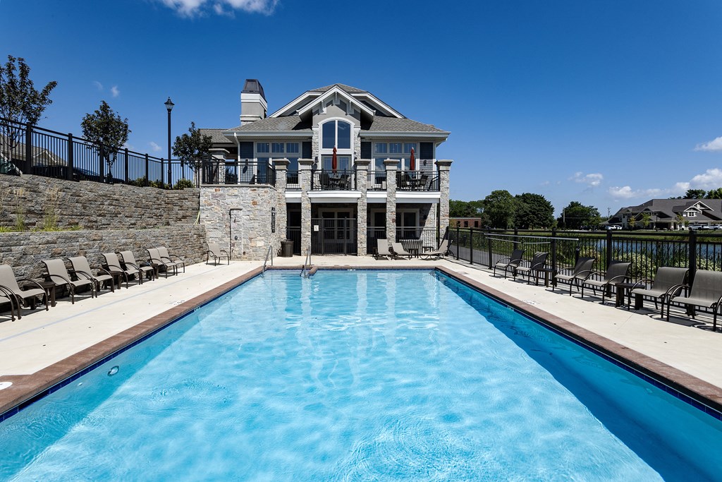 a pool with a house in the background