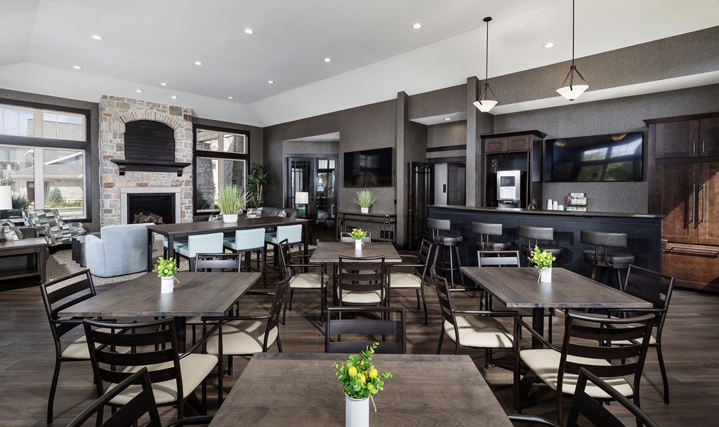a large dining room with tables and chairs and a fireplace