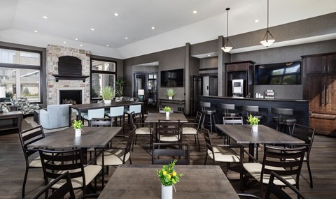 a large dining room with tables and chairs and a fireplace