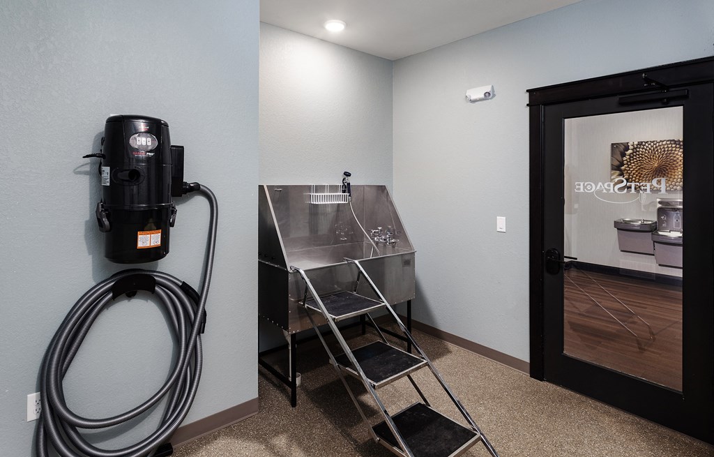 a utility room with a coffee machine and a stainless steel sink