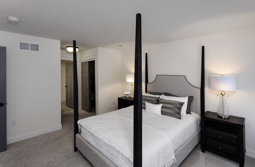 a bedroom with a large bed and two night stands