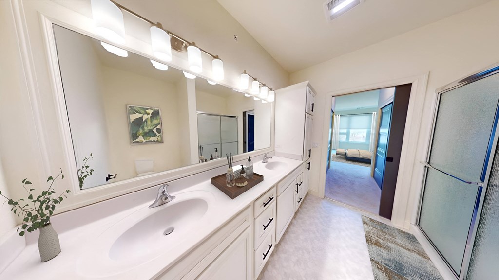 a bathroom with two sinks and a large mirror