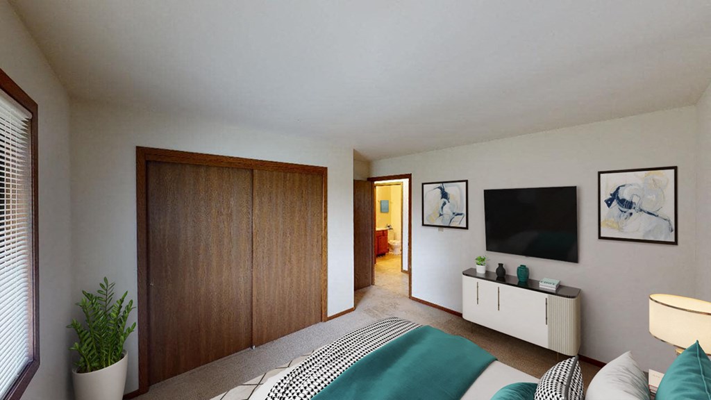 a bedroom with a bed and a wooden closet