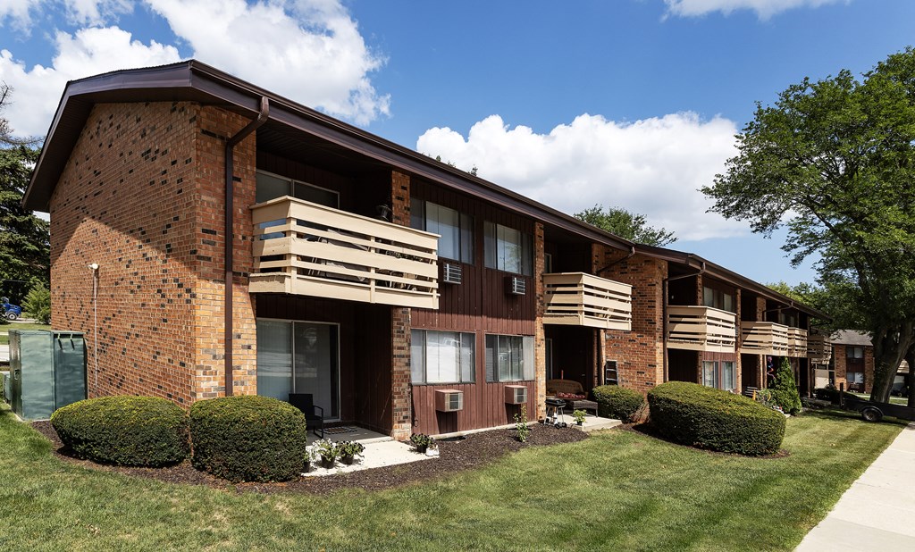 a brick apartment building with wooden balconies
