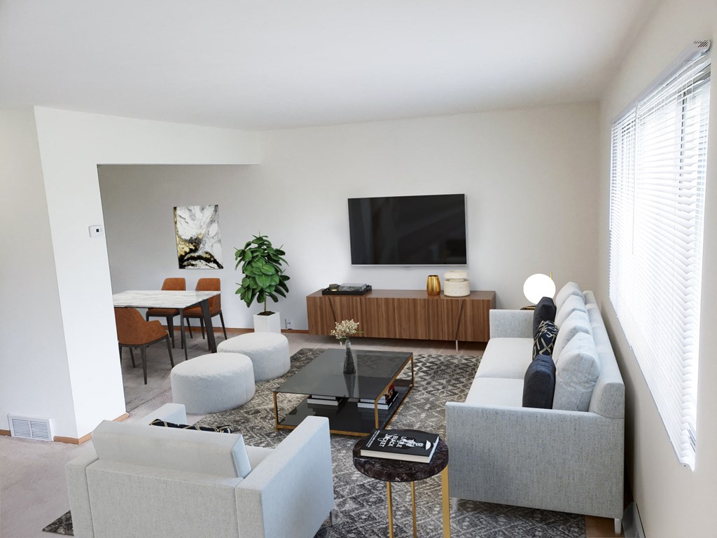 a living room with couches and a table and a television