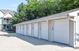 a row of white garage doors on the side of a house