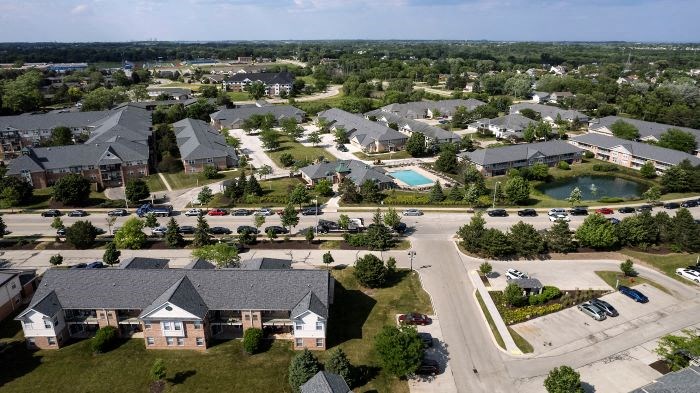 an aerial view of a neighborhood with houses and a swimming pool