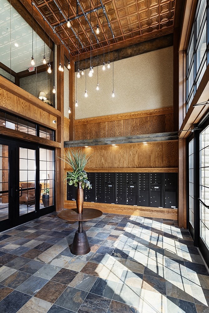the lobby of a building with a plant in a vase